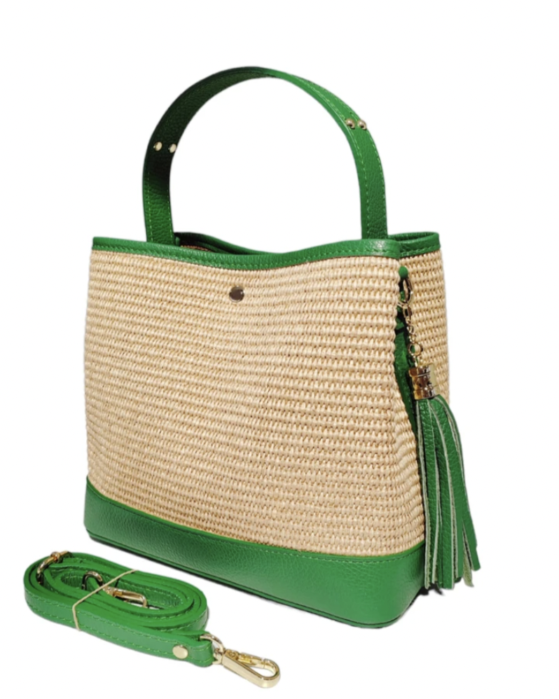 Woven handbag with green accents and a matching strap on a white background